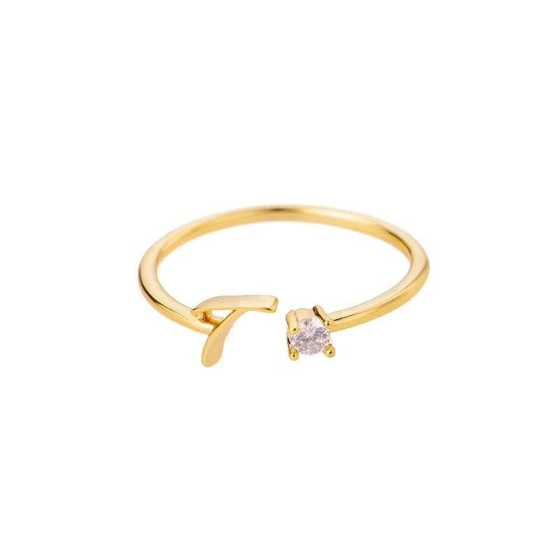 Infinity gold ring featuring a delicate open design with a small sparkling crystal accent, embodying modern sophistication and timeless elegance in fine jewelry.